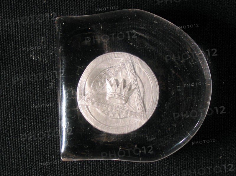 Paperweight with inclusion of a crowned triangle.