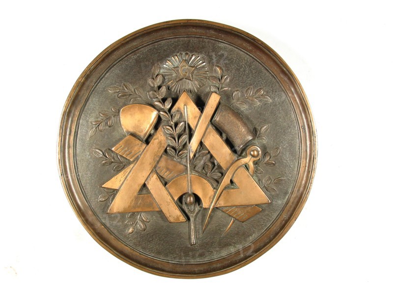 Bronze medallion with a composition of working tools.