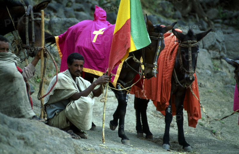 STEED MINDER AT FUNERAL, ;LALIBELA, ETHIOPIA