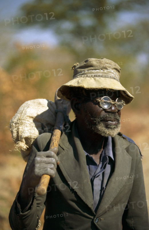 ELDERLY ZIMBABWEAN MAN WITH "DO IT YOURSELF" SPECTACLE REPAIRS, ZIMBABWE