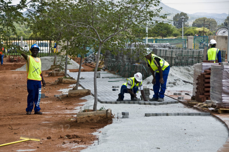 Workers lay paving at The Royal Bafokeng Sports Palace in Phokeng near Rustenburg.  The stadium will be used for 2010 FIFA World Cup Soccer.