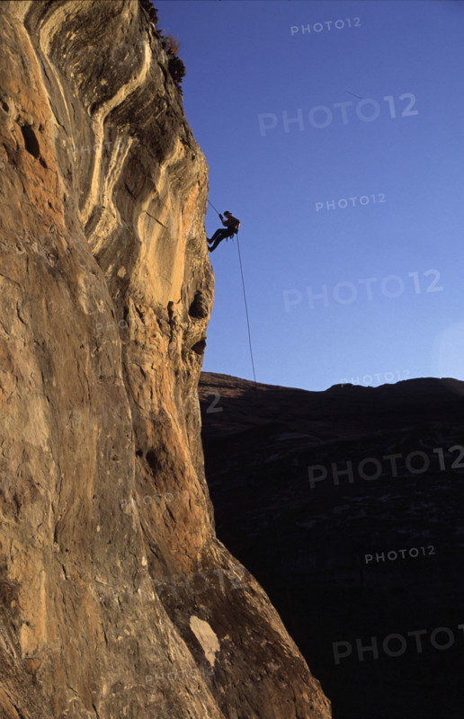 abseiler silhouetted against the sky