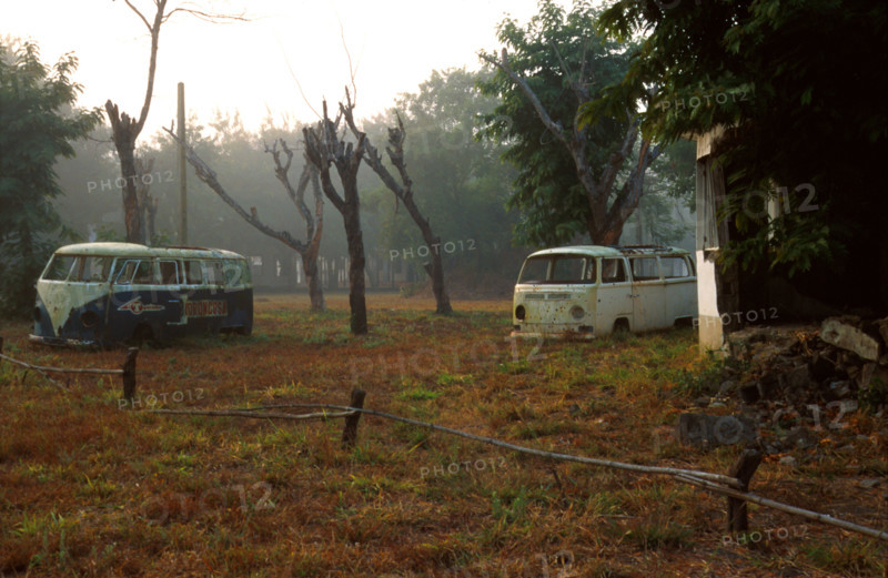 remains from the war - bombed out rondavels and vehicles