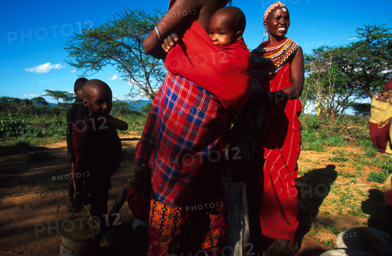 Women at Nagorowuro get ready to walk home after collecting their ration of grain