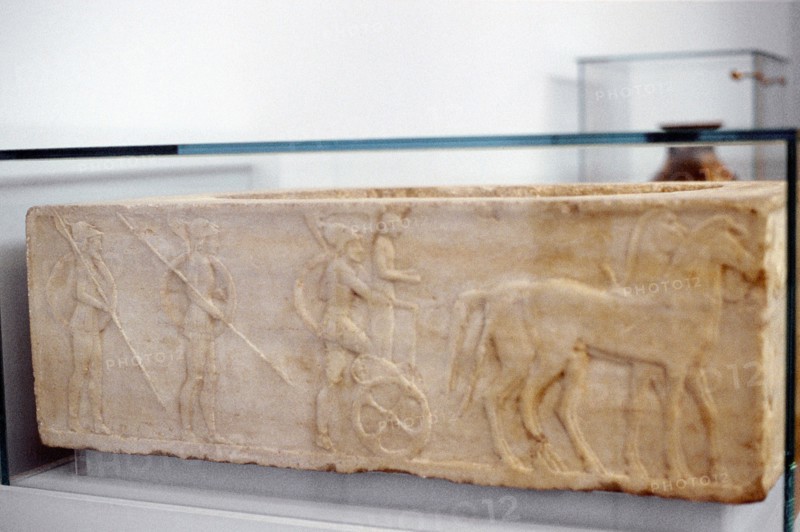 Ancient Greek warrior stepping into his chariot