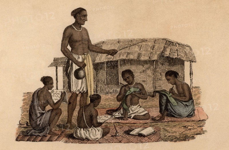 Hindu schoolmaster overseeing four boy pupils
