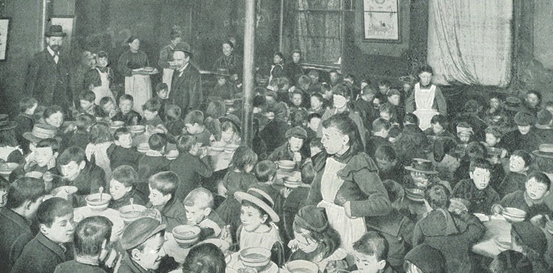 School children in the East End of London being served with free meals, c1910