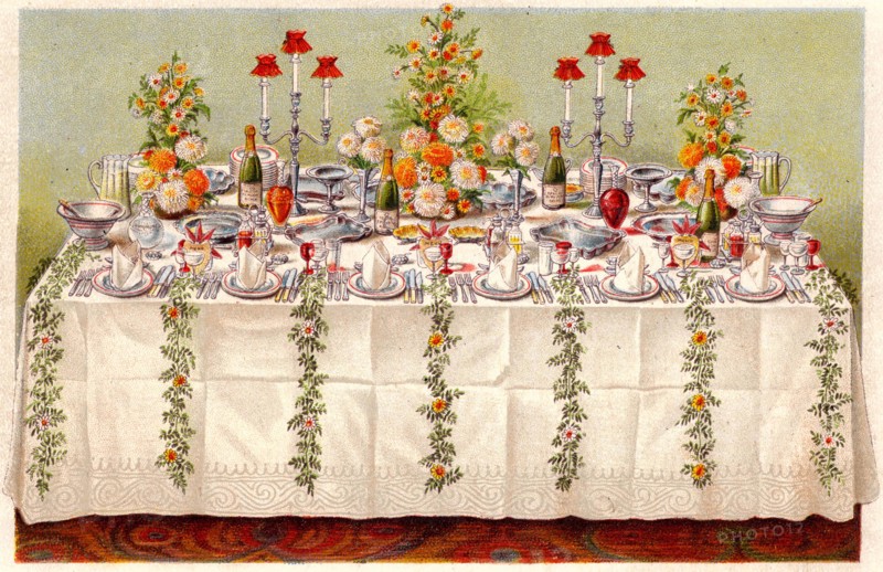 Table covered with a linen cloth and set for a buffet for ball or an evening party