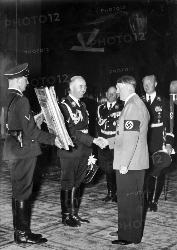 Heinrich Himmler offers Adolf Hitler a confiscated painting