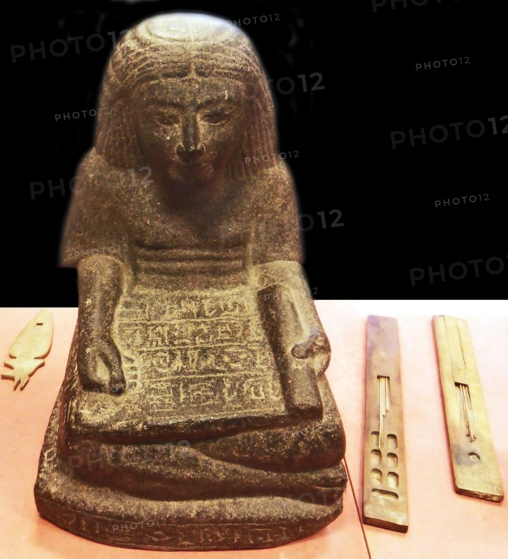 Scribe sitting cross-legged