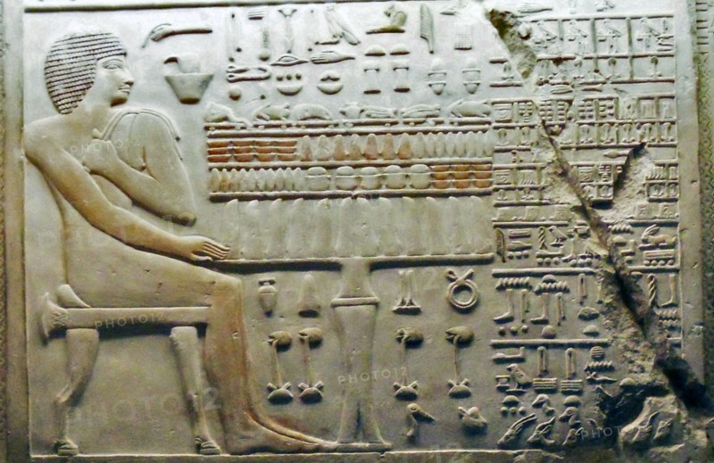 Bas relief Egyptian depicting a seated male figure