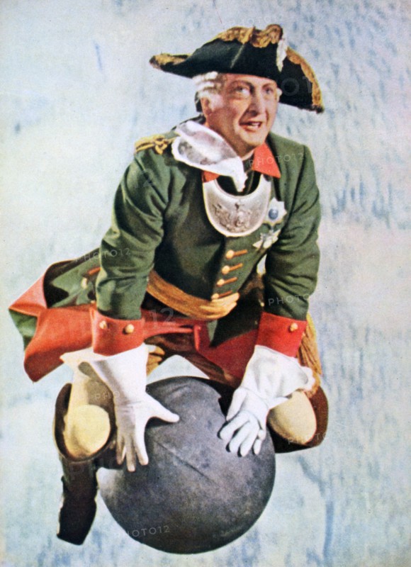 Hans Albers as Baron Munchausen riding on a canon ball