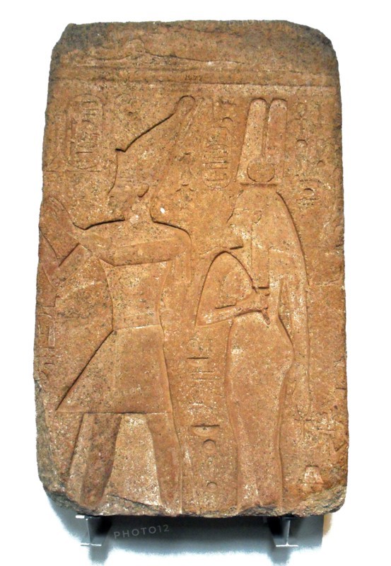 Queen Karoma and King Osorkon of Egypt standing before a god