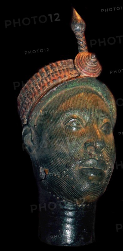 Brass head with a beaded crown and plume