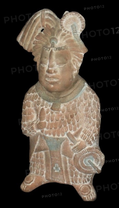 Mayan priest holding a knife and a fan