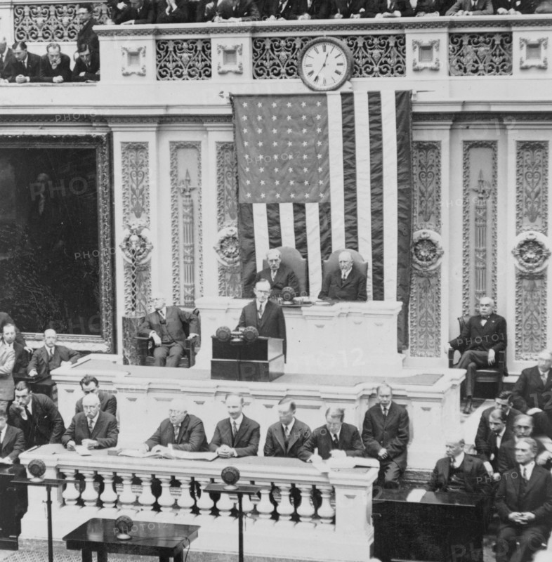 President Calvin Coolidge addressing the US Congress, Warren Harding is seated to the right of the Speaker