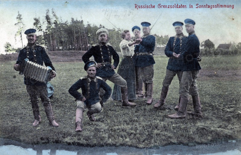 Russian border guards and one woman in dance poses. 1900