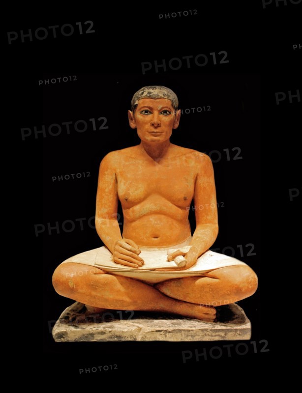 Scribe sitting cross-legged with a papyrus in his lap 2350 B
