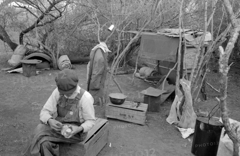 White migrant worker living in camp with two other migrant men