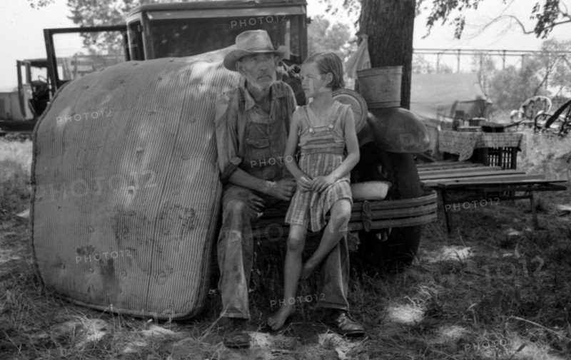 Veteran migrant agricultural worker with his daughter camped on Arkansas River, Wagon County, Oklahoma By Russell Lee, 1903-1986, photographer 19390101.
