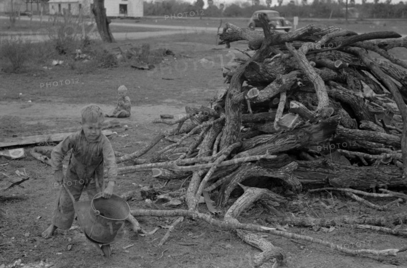 Child of white migrant worker playing with automobile tools near Harlingen, Texas By Russell Lee, 1903-1986, photographer Date 19390101.