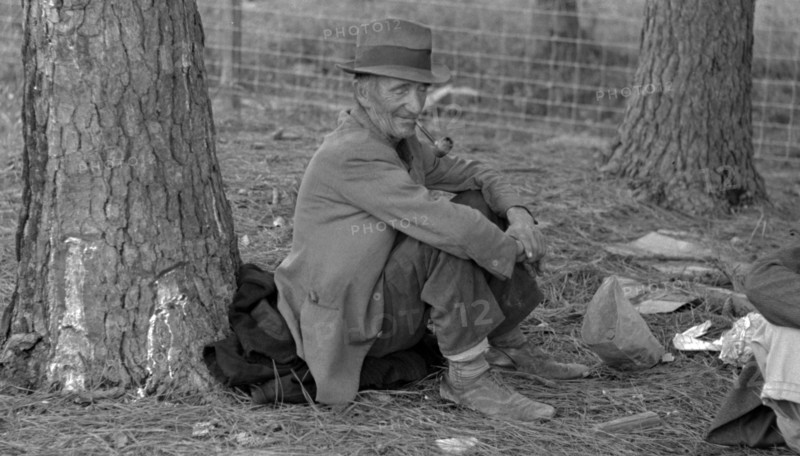 Migrant worker resting at roadside, Hancock County