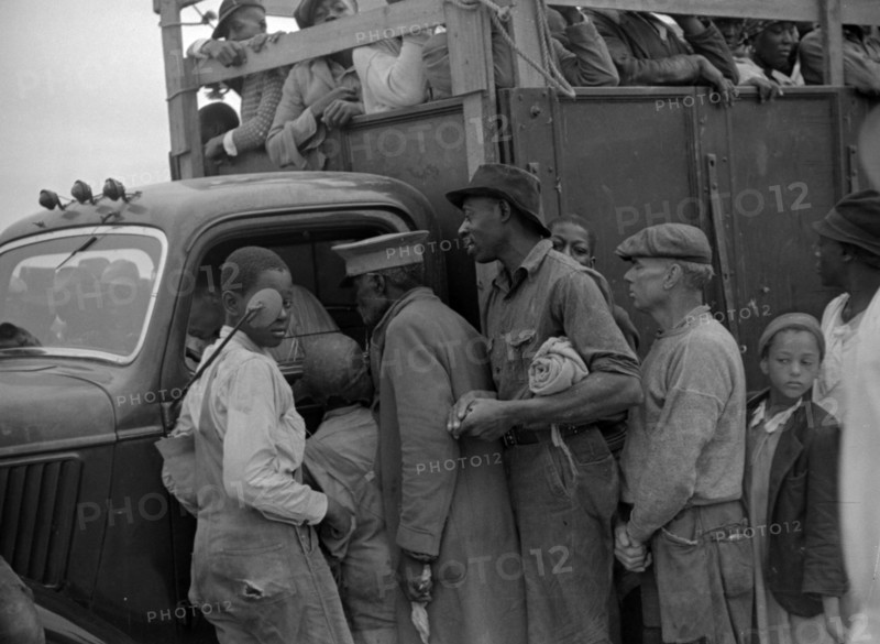 Untitled photo, possibly related to: Vegetable workers, migrants, waiting after work to be paid. Near Homestead, Florida By Russell Lee, 1903-1986, photographer Date 19390101.