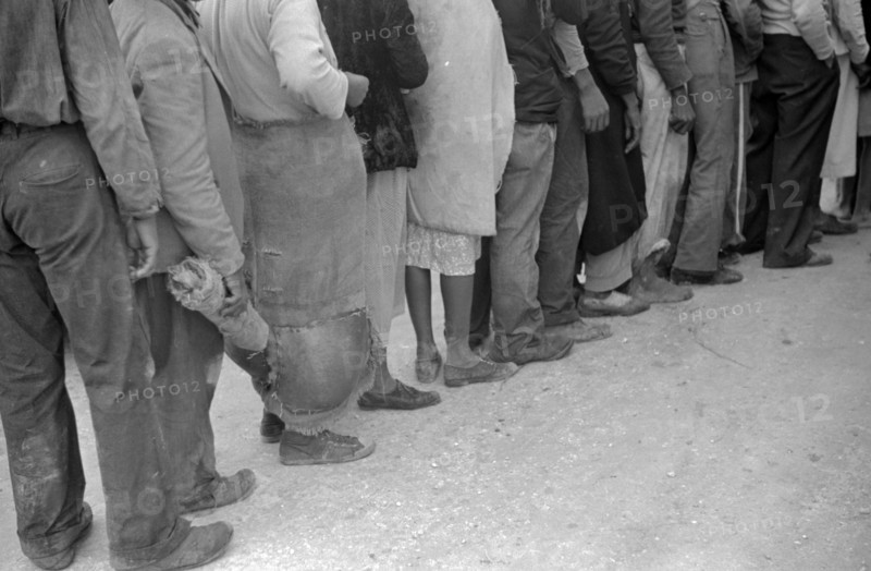 Vegetable workers, migrants, waiting after work to be paid. Near Homestead, Florida dated 19380101