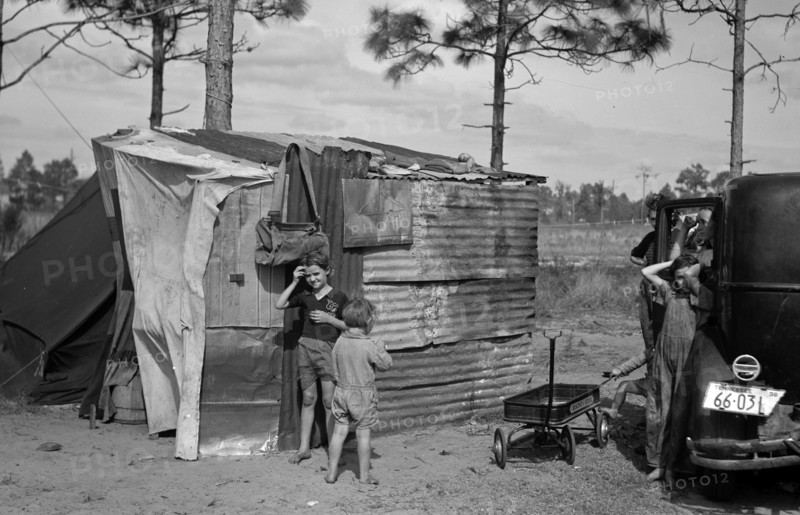 The temporary home of a migrant citrus worker and his family. Now camped near the packing plant of Winterhaven, Florida. The family is originally from Tennessee dated 19370101