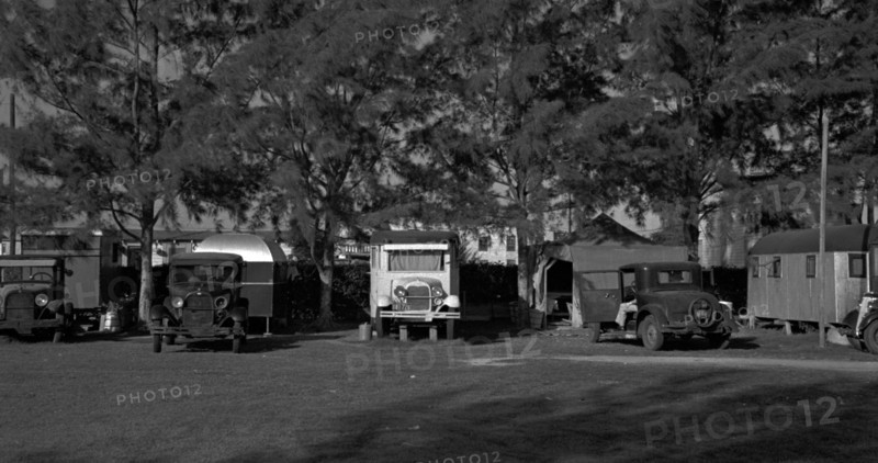Autos and trailers encamped in a tourist camp used by migrant fruit workers, near Belle Glade, Florida 19370101
