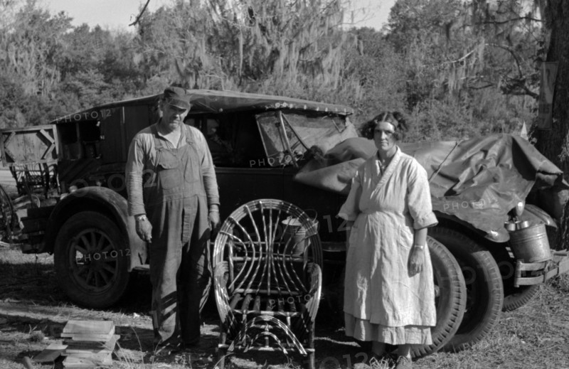 Migrant cane chair maker and wife in front of their automobile home, near Paradis, Louisiana 19380101