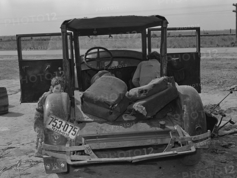 Car of white migrant worker being repaired by owner 19390101