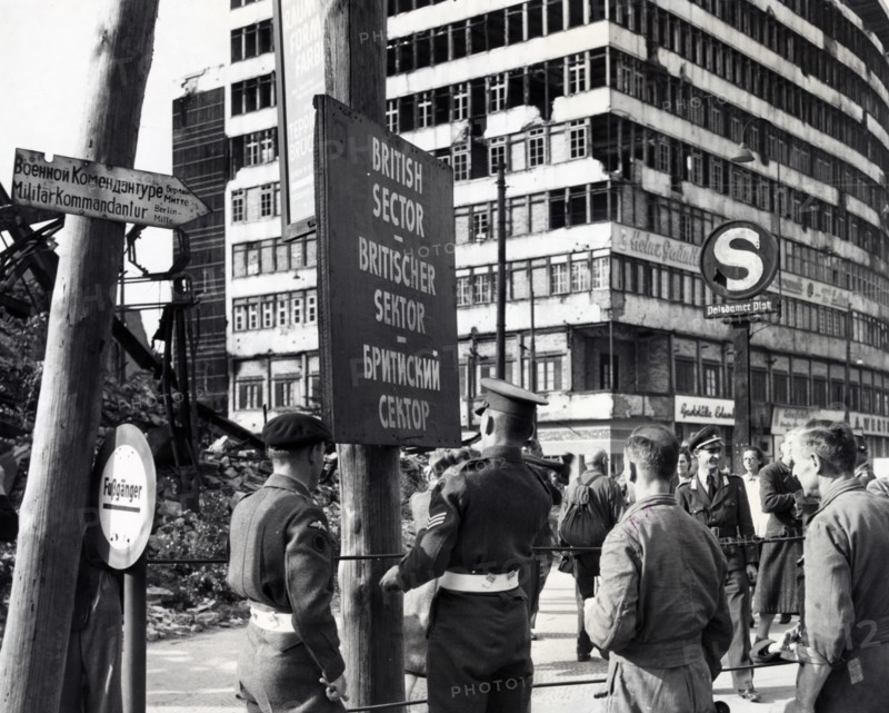Photograph of British military police erecting a sign to mark division of the British and Russian sectors of Berlin