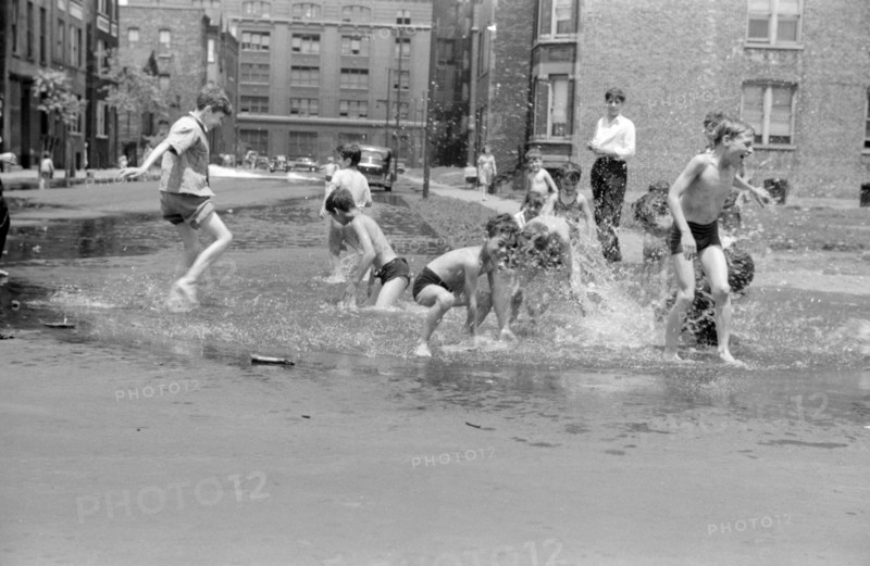 Untitled. Cooling off in water from hydrant, Chicago, Illinois July 1941.