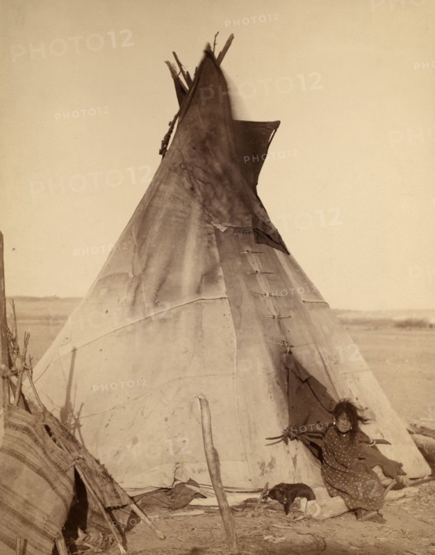 Photographic print of a young Oglala girl sitting in front of a Tipi