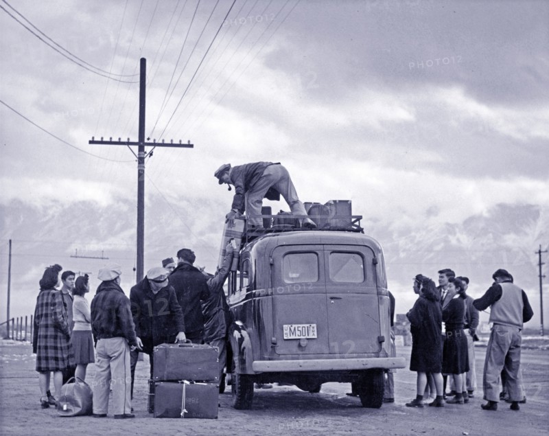 Photographic print of a loading bus leaving Manzanar for relocation