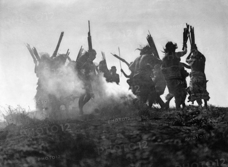 Photographic print of Kwakiutl people performing a ritualistic dance to restore an eclipsed moon
