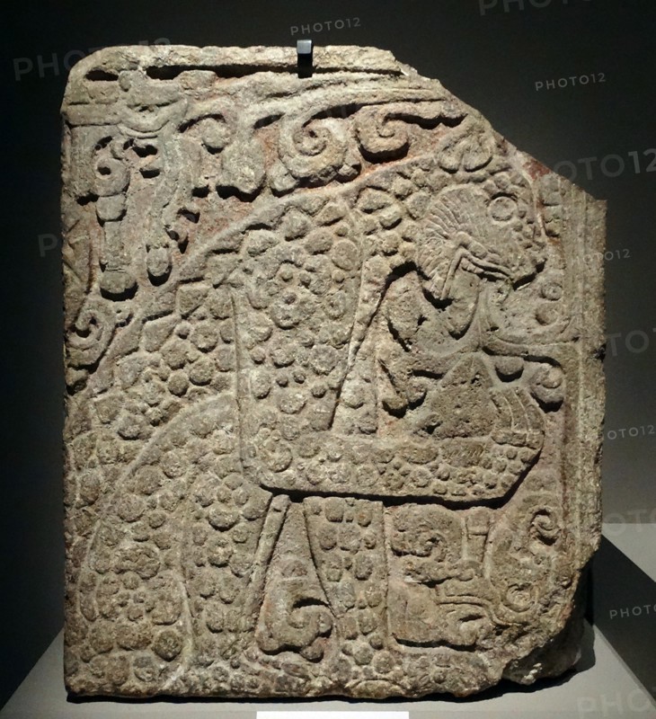 Mayan, calcified stone panel, with bas relief depicting a jaguar eating a heart.