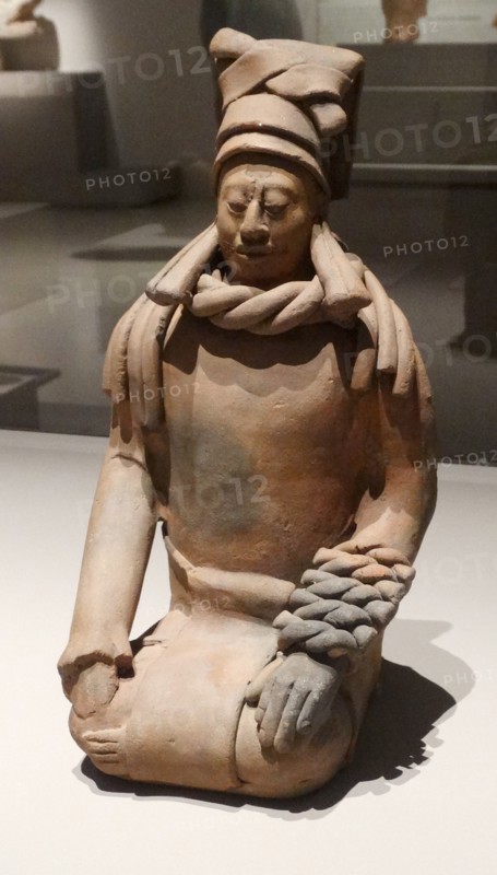 Mayan ceramic figurine of a kneeling female shaman or priestess.