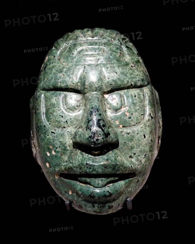 Face of the Maya Sun God carved in a green stone,