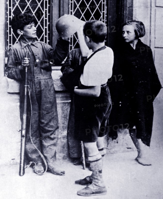 Children play like soldiers, during the Spanish Civil War