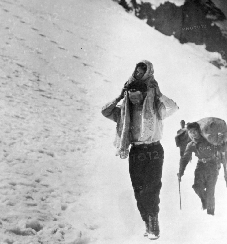 Refugees cross snow covered mountains, during the Spanish Civil War