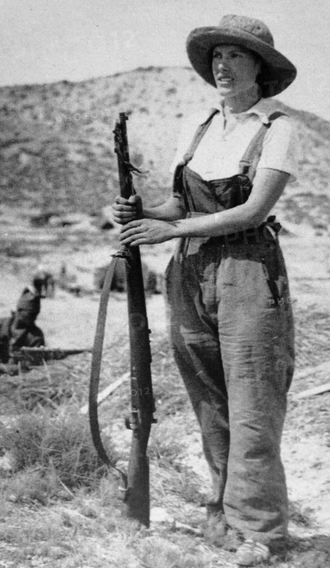 woman civilian stands guard with a rifle during the Spanish Civil War