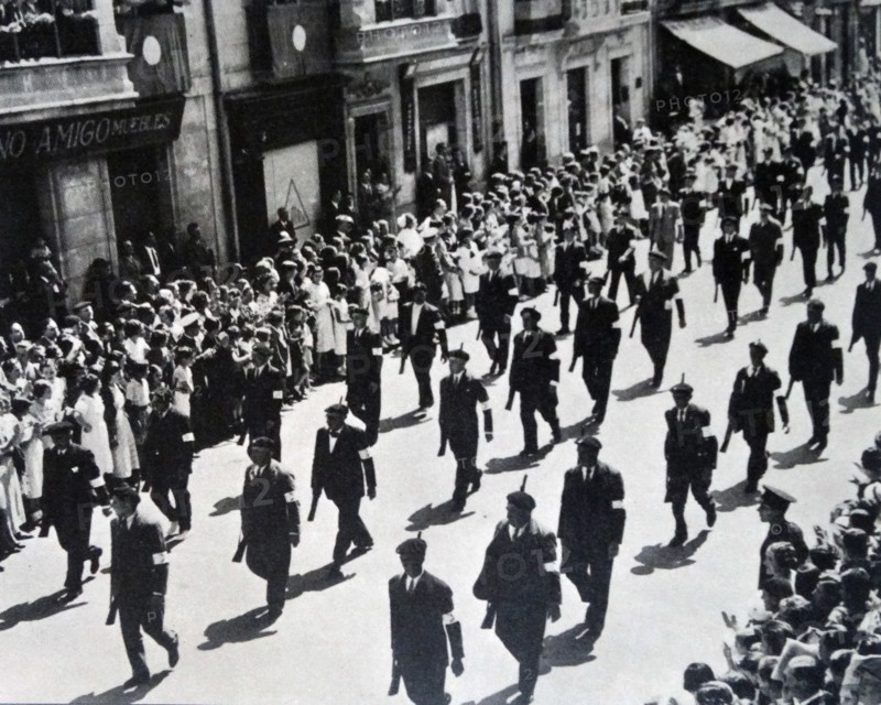 Militia men march through a town in Spain during the Spanish Civil War