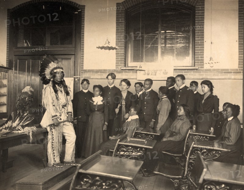 Louis Firetail (Sioux, Crow Creek), wearing tribal clothing