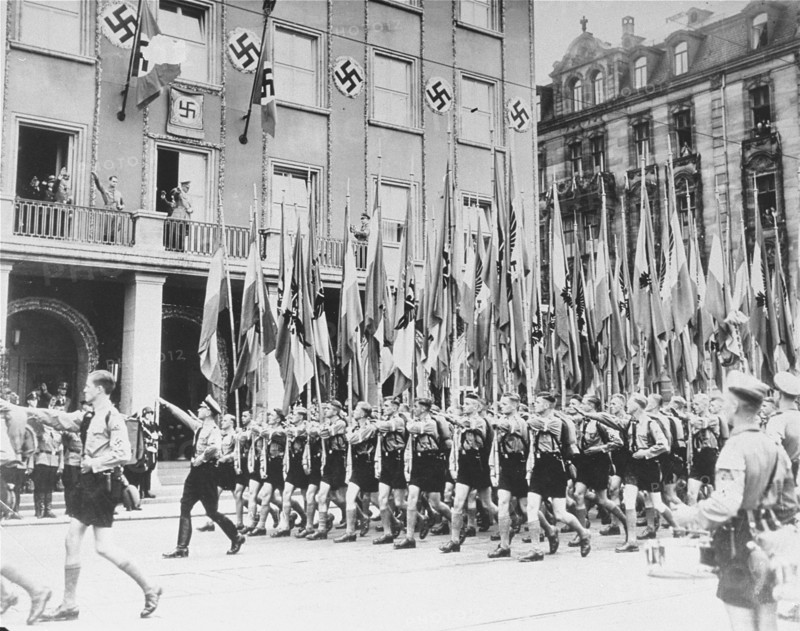 Photograph of Hitler Youth members marching in celebration of Adolf Hitler's Birthday
