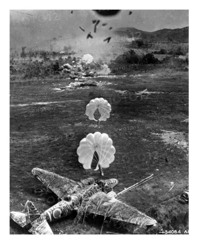Photograph of a Mitsubishi Ki-21 under attack on airfield