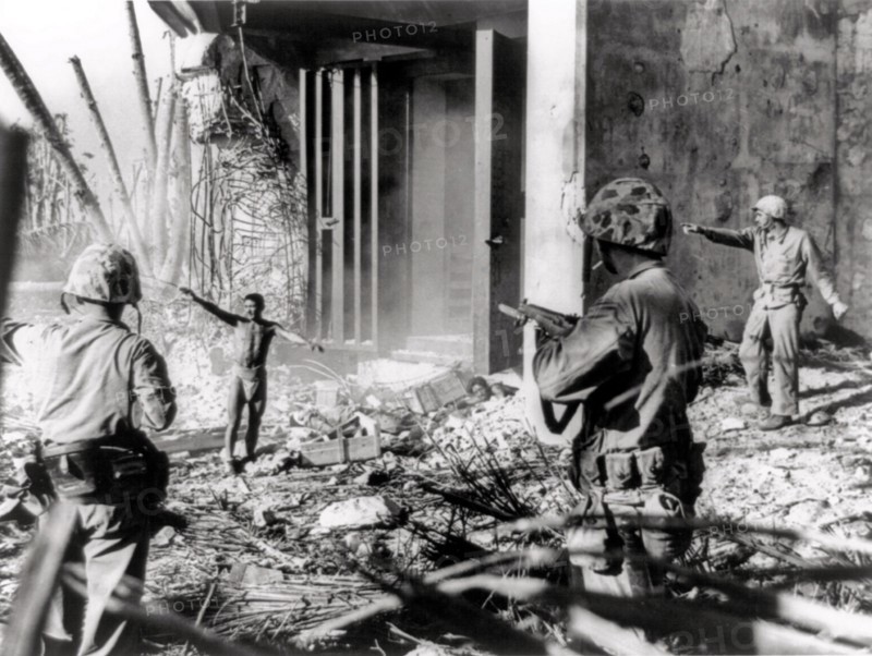 Photograph of Japanese soldiers surrendering to US soldiers,