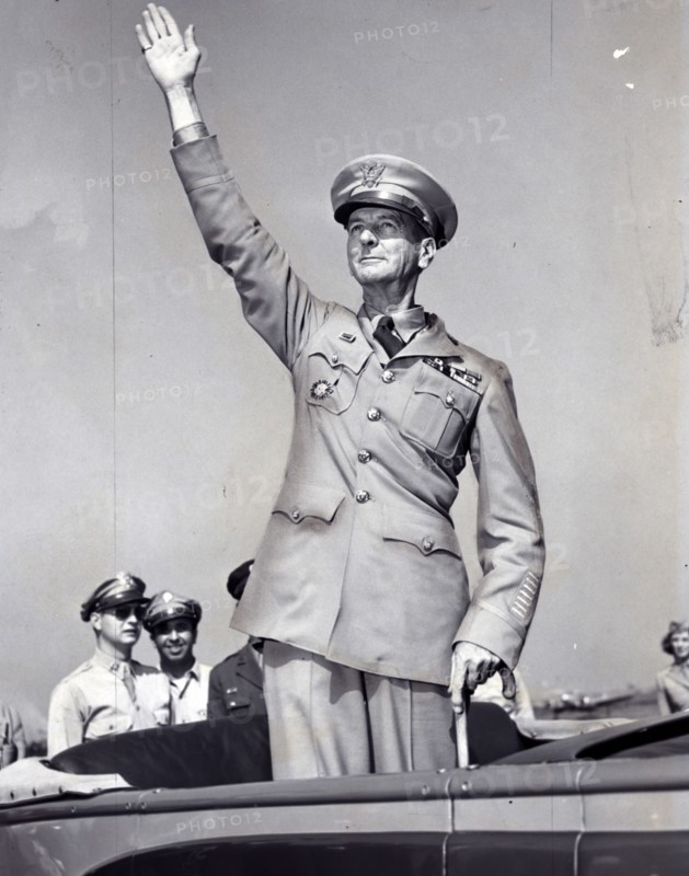 General Wainwright, standing in car, waving to crowd gathered at La Guardia