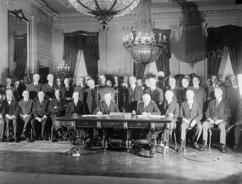 Photograph of President Calvin Coolidge signing the Kellogg Treaty